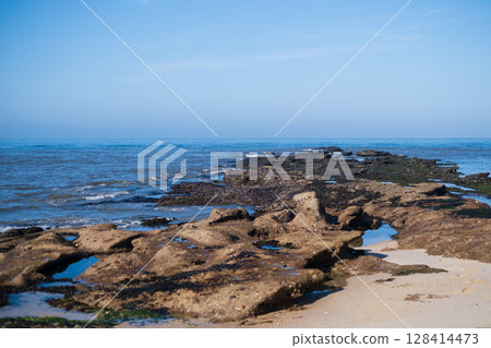 View of Rocks Exposed During Low Tide on the Ocean Shore in Portugal View of Rocks Exposed During Low Tide on the Ocean Shore in Portugal 128414473