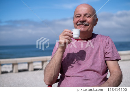 Little Girl Playing with Her Grandfather on the Beach During Summer Vacation 128414500
