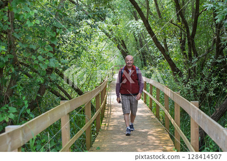 Elderly European Man Walking on an Eco-Trail in Portugal Elderly European Man Walking on an Eco-Trail in Portugal 128414507