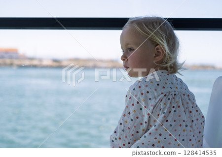 European girl sailing on a ferry and looking out the window European girl sailing on a ferry and looking out the window 128414535