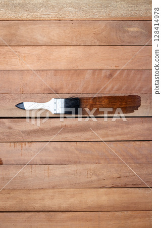 Paint brush and wood material in construction work. Paint brush and wood material in construction work. 128414978
