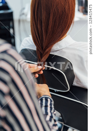 hairdresser does hair with hair in salon 128415475