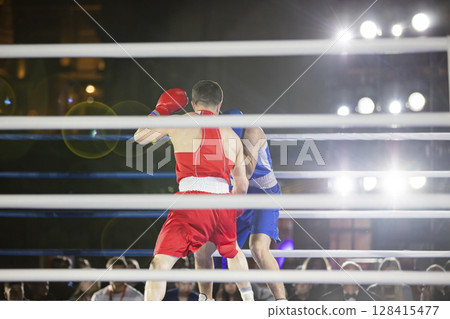 Fight of sportsmen in gloves in the ring Fight of sportsmen in gloves in the ring 128415477