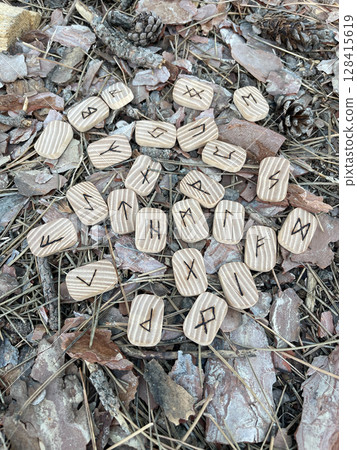 magical wooden runes on the ground 128415619