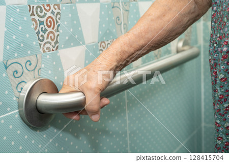 Asian elderly woman patient use toilet bathroom handle security in nursing hospital, healthy strong medical. 128415704