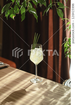 Elegant cocktail with lemongrass in wine glass Elegant cocktail with lemongrass in wine glass 128415996