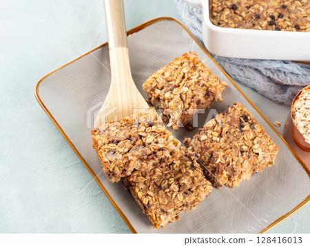 Baked oatmeal peanut butter banana cake bars with chocolate chips 128416013