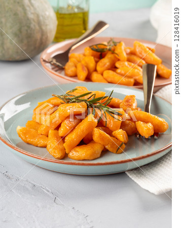 Pumpkin recipe homemade gnocchi on pastel color background 128416019