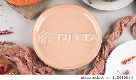 Fall thanksgiving table setting pumpkin decor flatlay with pink dish 128416030