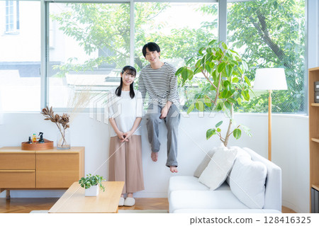 A young couple relaxing in the living room A young couple relaxing in the living room 128416325