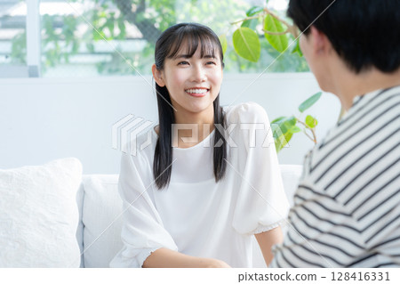 A young couple relaxing in the living room A young couple relaxing in the living room 128416331
