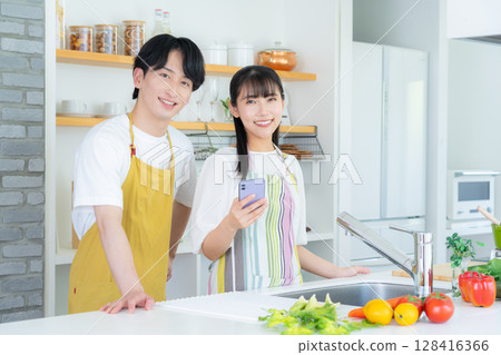 Young couple cooking in the kitchen 128416366