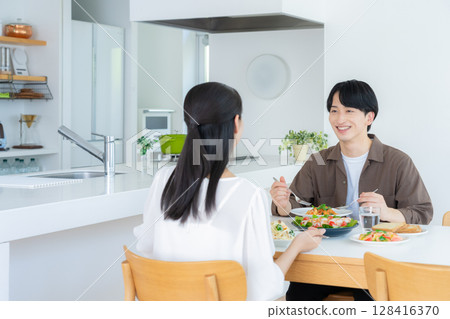 Young couple eating in the dining room Young couple eating in the dining room 128416370