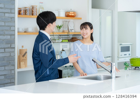 Real estate agent explaining to a woman in the kitchen Real estate agent explaining to a woman in the kitchen 128416394