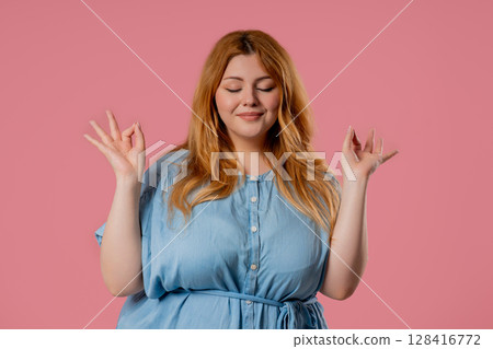 Tranquil overweight woman relaxing, meditating, stress. Body positive lady 128416772