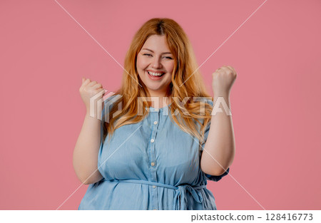 Plus size happy woman with triumph yes victory gesture. Jackpot, win, success Plus size happy woman with triumph yes victory gesture. Jackpot, win, success 128416773