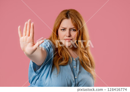 Uninterested plus size Woman Disapproving With No Hand Sign. Denying, Rejecting Uninterested plus size Woman Disapproving With No Hand Sign. Denying, Rejecting 128416774