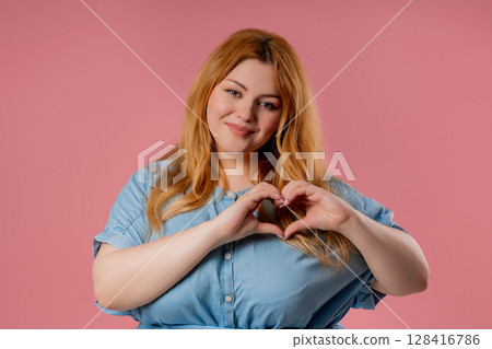Body positive woman smiling showing heart shape sign. Kindness,self-love,support Body positive woman smiling showing heart shape sign. Kindness,self-love,support 128416786