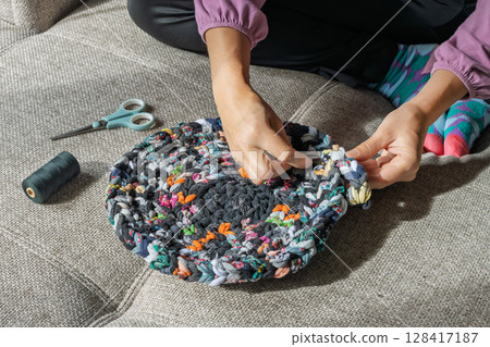 Handcrafted rug making from fabric scraps Handcrafted rug making from fabric scraps 128417187