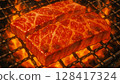 The meat is slowly grilled over charcoal. It looks delicious. 128417324