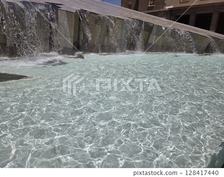 Tranquil fountain cascading water in Zaragoza urban landscape. Aragon, Spain. Summer in Zaragoza. Travel in Spain 128417440