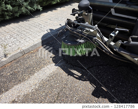 Urban cleanliness concept with street sweeper close-up on pavement. A street sweeper or street cleaner 128417786