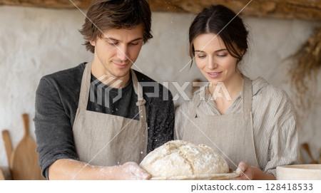 Couple shares a cozy moment as they bake sourdough bread in a warm and inviting kitchen 128418533