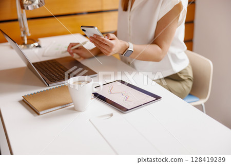 Prioritize Productivity Modern Workspace with Laptop, Smartphone, and Mobile Devices 128419289