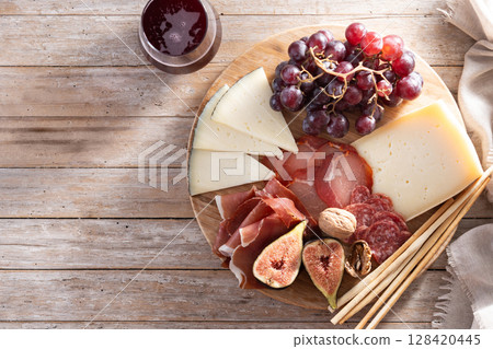 Charcuterie Board with Cheese, Grapes, and Figs 128420445