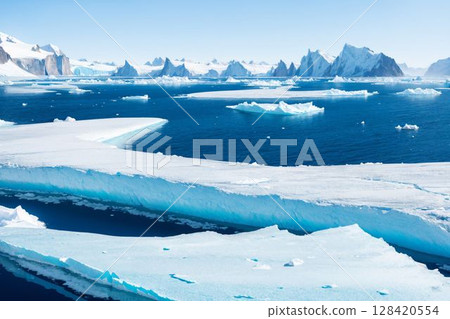 A mysterious natural panorama created by polar sea ice and snow-capped mountains 128420554