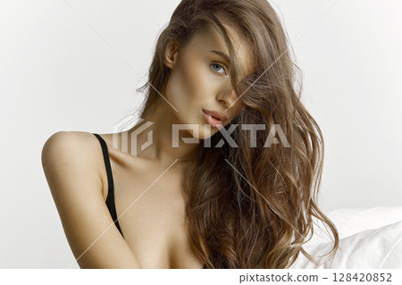 brunette girl with healthy curly hair. beautiful young woman brunette girl with healthy curly hair. beautiful young woman 128420852