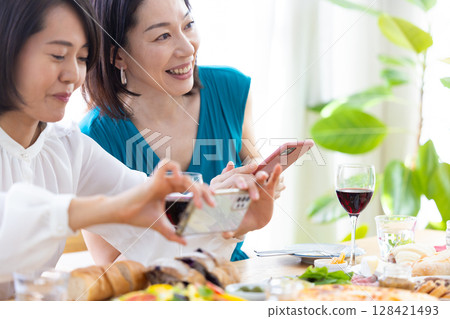 A woman taking a photo of party food 128421493