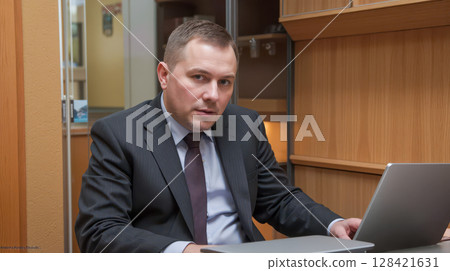 Corrupt government official in suit sits at his desk during an investigation for bribery, a shady politician involved in financial crime scheme for money 128421631