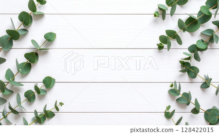 Green leaves frame a wooden background with a fresh floral border illustrating natural spring foliage 128422015
