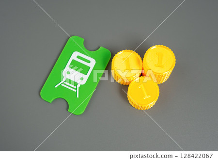 A public transport ticket and a stack of coins. A metro, tram or train ticket. 128422067
