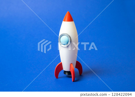 Space rocket on blue background. Concept of space aerotechnics. Advertising, startups. Advanced engineering, scientific progress, or marketing for aerospace. Tech innovation Space rocket on blue background. Concept of space aerotechnics. Advertising, startups. Advanced engineering, scientific progress, or marketing for aerospace. Tech innovation 128422094