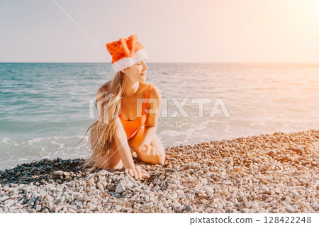 Woman in Santa Hat on a Pebble Beach 128422248