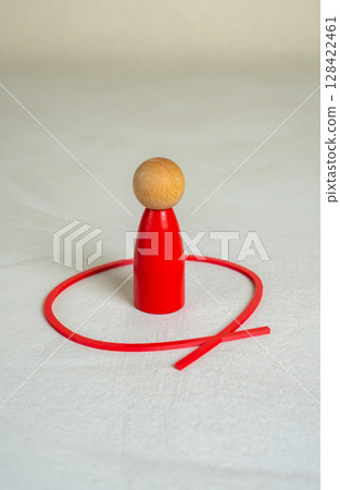The red man is outlined by a red line. Limit yourself. Find your place. Introspection, individual boundaries, or emotional withdrawal in social contexts. 128422461