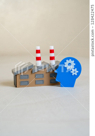 An industrial plant and a head with gears symbolizing intelligence and technology. Innovation, automation, or intellectual capital in manufacturing. 128422475
