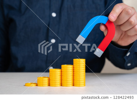 A man with a magnet increases his profits. Successful attraction of capital, increased revenue streams, and effective business development strategies to boost income. 128422493