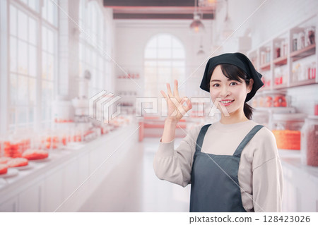 Young woman working in a bakery Young woman working in a bakery 128423026
