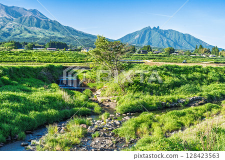 A rural landscape with a blue sky and Mount Aso (Minamiaso Village) in the background A rural landscape with a blue sky and Mount Aso (Minamiaso Village) in the background 128423563
