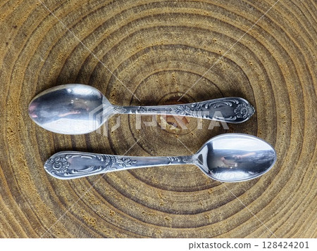 Dnipro, Ukraine - July 13, 2025: A set of vintage tea spoons made of cupronickel covered with silver. The spoons were made in USSR and are marked with a quality mark. Dnipro, Ukraine - July 13, 2025: A set of vintage tea spoons made of cupronickel covered with silver. The spoons were made in USSR and are marked with a quality mark. 128424201