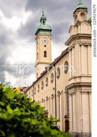 Historic Church Of The Holy Spirit In Munich: Elegant Baroque Architecture With Tower And Facade Near Marienplatz Under Dramatic Cloudy Sky Historic Church Of The Holy Spirit In Munich: Elegant Baroque Architecture With Tower And Facade Near Marienplatz Under Dramatic Cloudy Sky 128424874