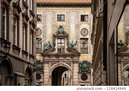 Munich Residenz Facing Residenzstrasse: Historic Royal Palace Entrance With Sculptures And Ornate Facade Between Narrow Streets In The City Center Munich Residenz Facing Residenzstrasse: Historic Royal Palace Entrance With Sculptures And Ornate Facade Between Narrow Streets In The City Center 128424949
