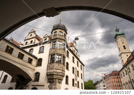 Historic Church Of The Holy Spirit In Munich: Elegant Baroque Architecture With Tower And Facade Near Marienplatz Under Dramatic Cloudy Sky 128425107