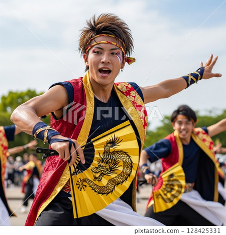 A young male dancer dancing vigorously at the Yosakoi Festival, holding a golden fan with a dragon design, sweating and dancing with messy hair 128425331
