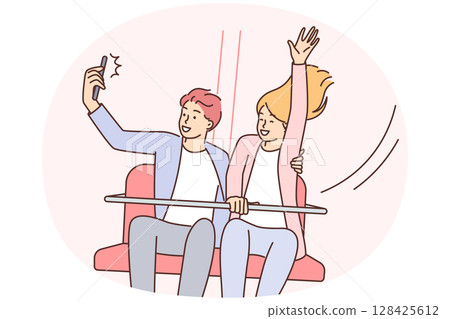 Happy couple ride attractions in park and take selfie for family photo album or love story video 128425612