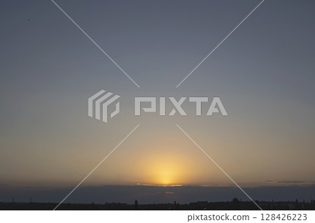 Beautiful sunset in the city with clouds and sun rays. The sun sets over the city. Beautiful sunset in the city with clouds and sun rays. The sun sets over the city. 128426223