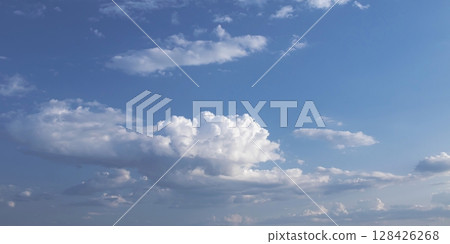 Blue sky with beautiful white clouds. Sky with cumulus and cirrocumulus clouds. Panoramic image of the sky. Blue sky with beautiful white clouds. Sky with cumulus and cirrocumulus clouds. Panoramic image of the sky. 128426268